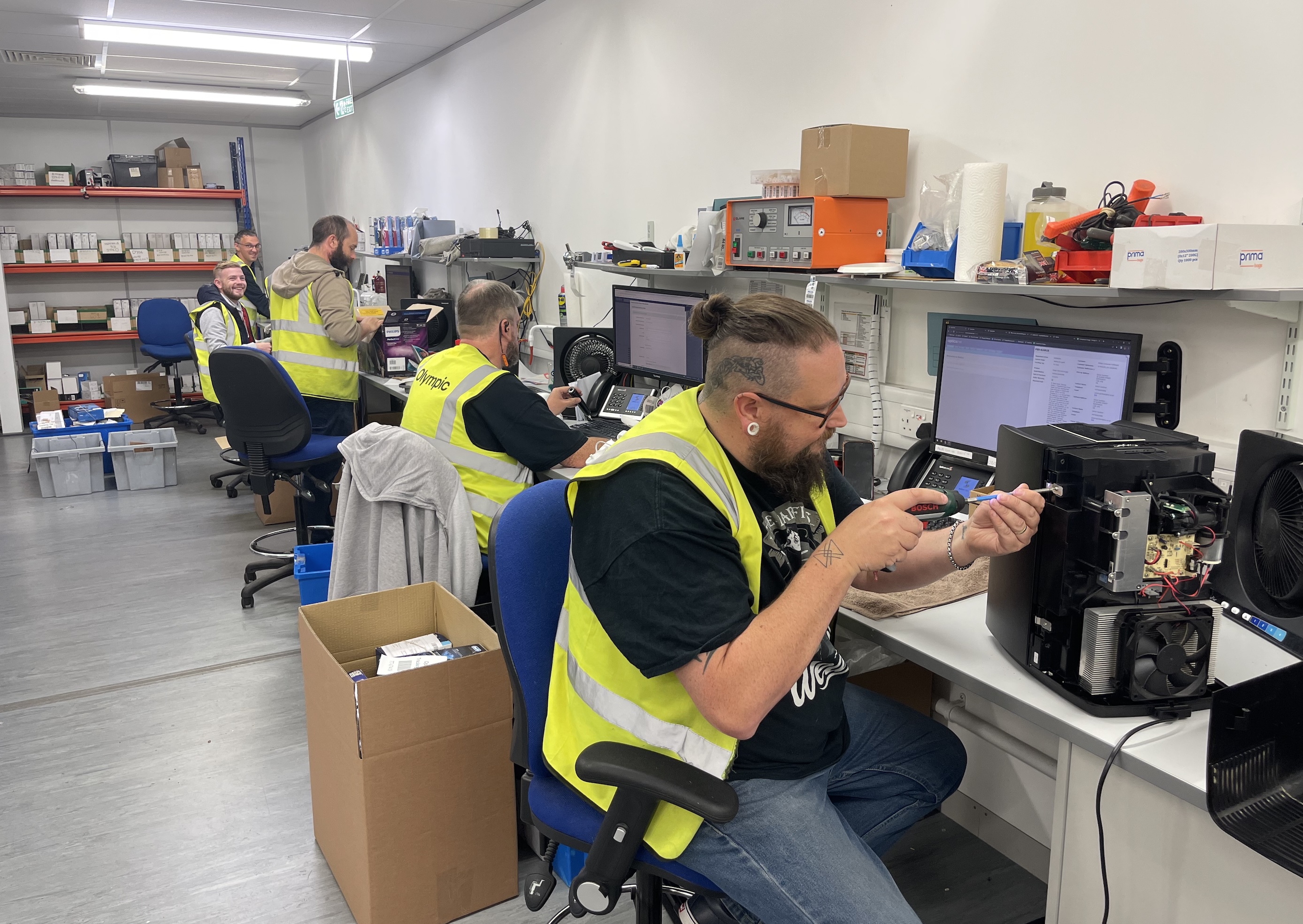 Olympic technicians at service and repair workstations